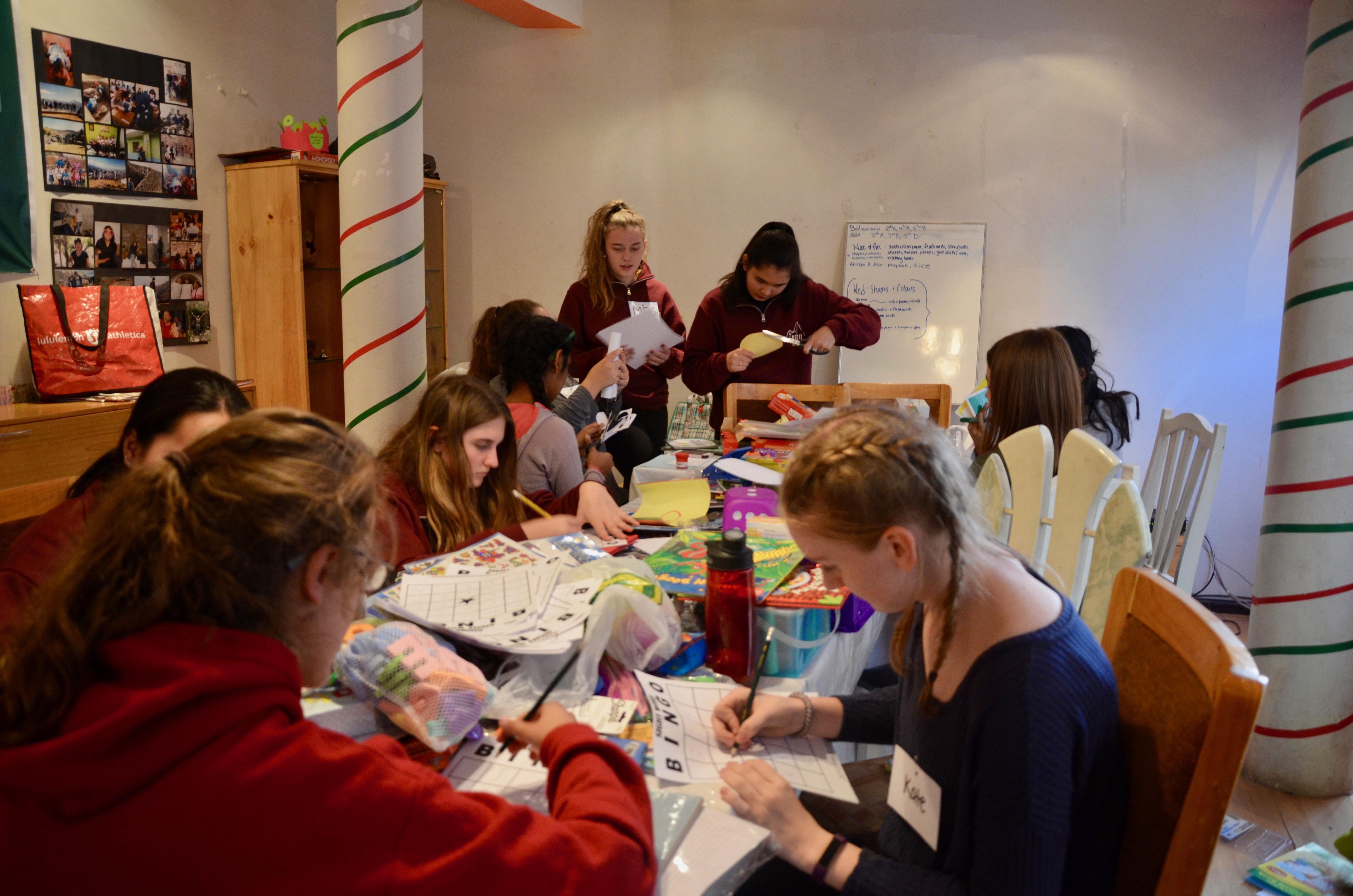 A group of Projects Abroad volunteers team up to create educational resources for their Childcare placement in Peru. Projects Abroad volunteers work together to create educational materials to help young children learn in Peru.